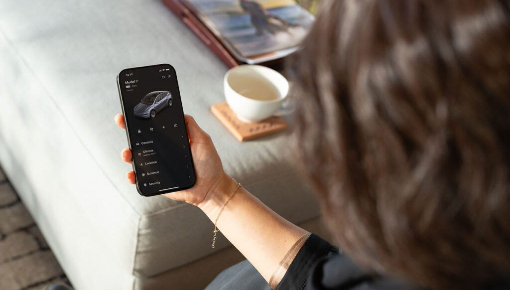 Official Tesla support image showing the Tesla app on a phone
